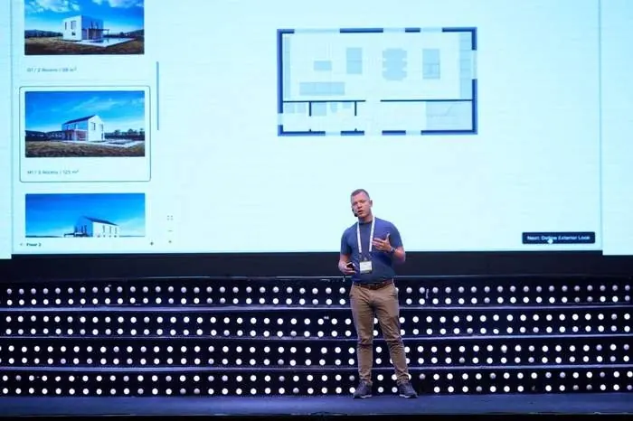 On stage in front of a screen showing the Lynx platform's house layout picker and floor plan