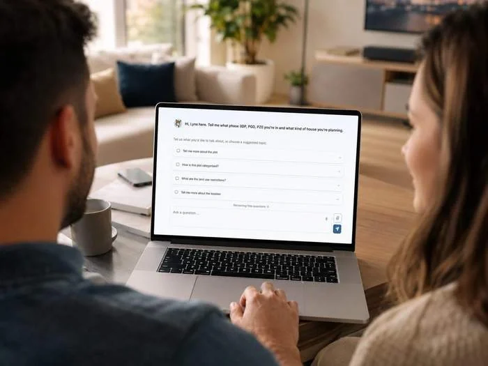 A couple at a laptop with the Lynx AI architect chat open, offering suggested questions about the plot
