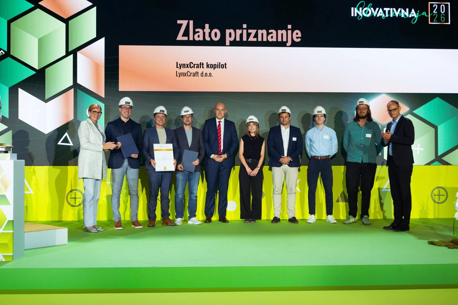 The LynxCraft team on stage at Innovation Day 2026, holding the gold award certificate.